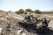 A damaged tank stands abandoned on a road near the Tigrayan city of Humera