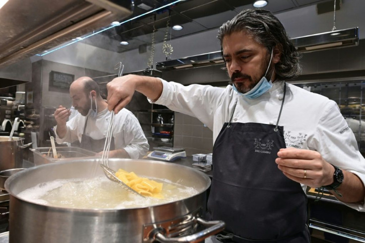 Chefs like Matteo Baronetto (R) donate their time and often use donated ingredients