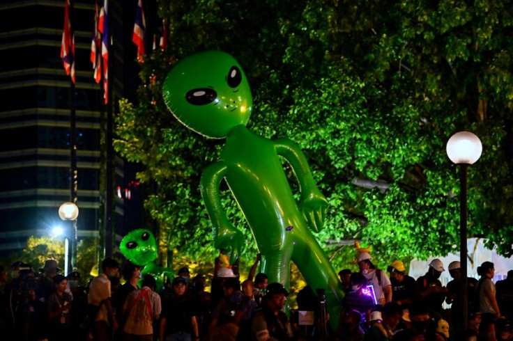 A large inflatable alien is displayed by Thai pro-democracy protesters demanding the king give up control of his multibillion-dollar fortune
