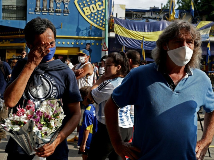 Fans of Argentine football legend Diego Maradona pay homage outside La Bombonera stadium in Buenos Aires on November 25, 2020, on the day of his death