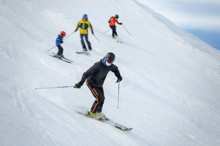 Skiers wearing protective face masks against the spread of the Covid-19 hit the slopes in the Swiss Alpine ski resort of Verbier on November 15, 2020