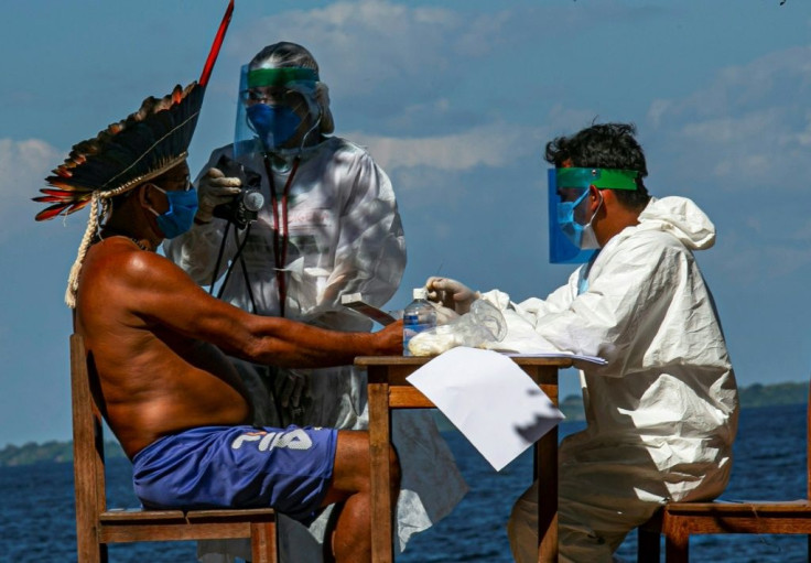 Getting vaccines to Amazon rainforest residents poses a special challenge for Brazilian healthworkers, who performed a rapid Covid test on Chief Domingos from the Arapuim tribe in July in Para state