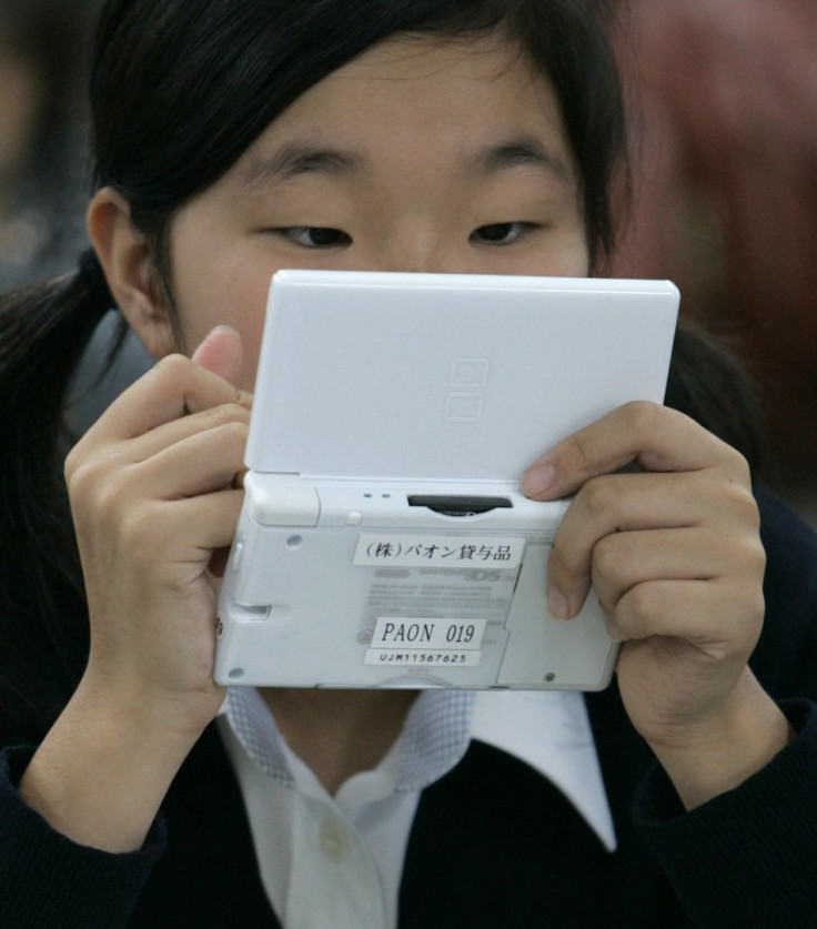 A student uses English-learning software on a Nintendo DS during a media event at Tokyo Girls Junior High School