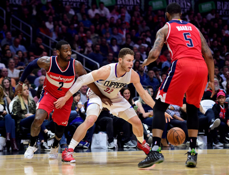 Blake Griffin #32 of the LA Clippers keeps his dribble from John Wall #2 and Markieff Morris #5 of the Washington Wizards