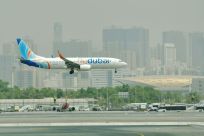 A flydubai Boing 737-800 lands at Dubai International Airport.
