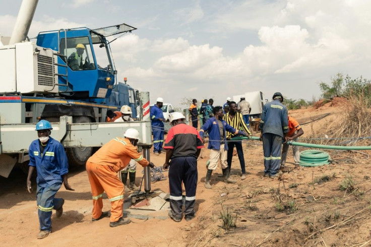 Rescuers pump water out of a flooded main shaft in a bid to open up a passageway to the trapped miners