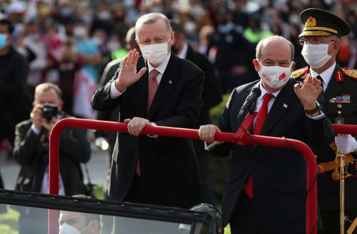 President Recep Tayyip Erdogan (L) and Turkish Cypriot leader Ersin Tatar lead a parade for the 37th anniversary of the self-proclaimed Turkish Republic of Northern Cyprus (TRNC) in the Turkish-held northern part of the divided capital Nicosia