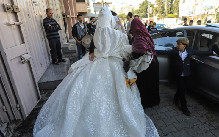 A veiled Palestinian bride leaves a beauty salon in the northern Gaza Strip