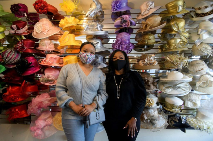 Meeka Robinson Davis, owner of One-Of-A-Kind Hats and daughter Chrstiana Davis at their store in the Windsor Hills neighborhood of Los Angeles -- Covid has hit business badly