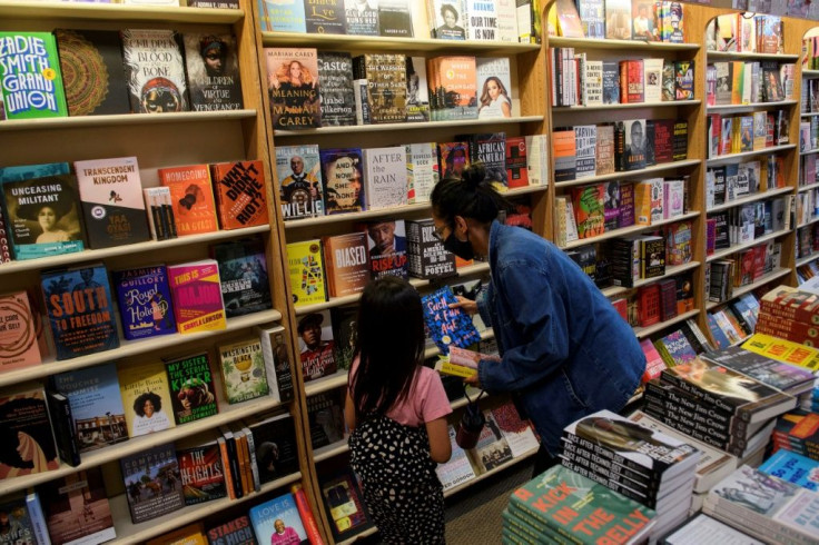 Customers browse books for sale at Eso Won Books in the Leimert Park neighborhood of Los Angeles, California -- the Black-owned small business limits the number of customers in the store