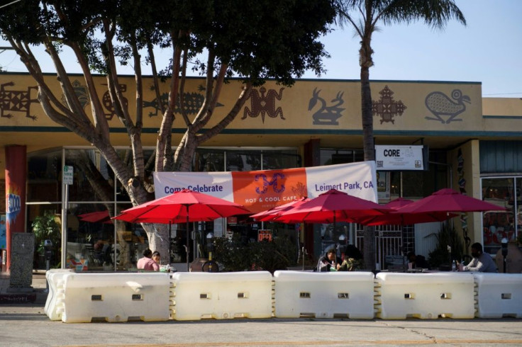 People eat outside Hot and Cool Cafe, a Black-owned small business in Leimert Park in Los Angeles, California