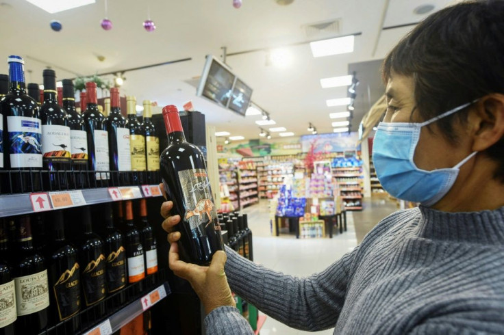 A woman looks at a bottle of Australian wine at a supermarket in Hangzhou, in eastern China's Zhejiang province. Beijing has hit Australian wine exports with punitive tariffs of up to 212 percent