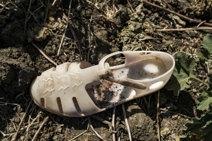 A blood-stained sandal lies next to the grave of an alleged victim of a massacre that unfolded in the Tigrayan town of Mai Kadra November 9