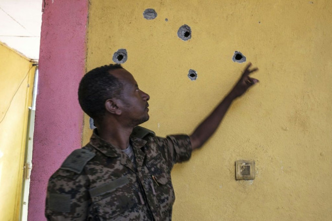 Impact: An Ethiopian soldier points to bullet holes left after the attack on the base in Dansha