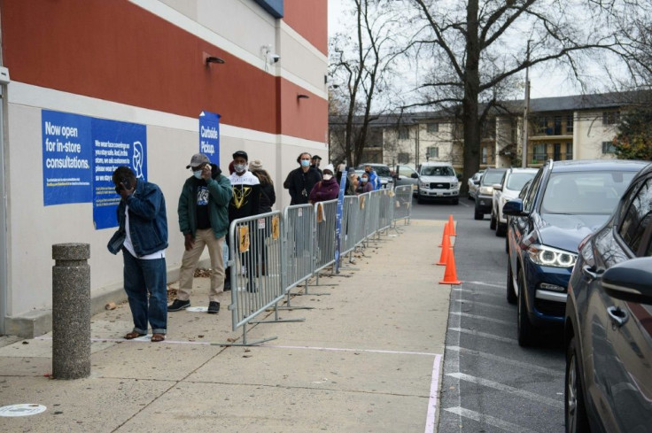 People queue to enter an electronics store on Black Friday in Wheaton, Maryland