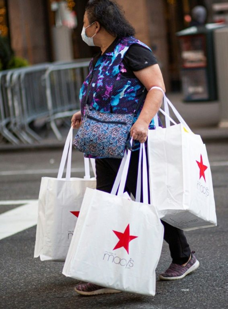 A shopper carries bags as she leaves Macyâs department store in New York on Black Friday