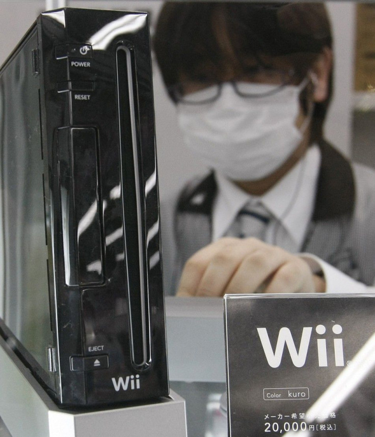 An employee arranges Nintendo Co's Wii game console at a Yamada Denki electronics retail store in Tokyo