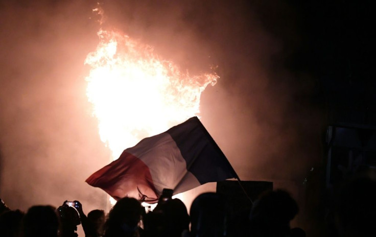 Demonstrators waved a burning French flag during a protest against the controversial 'global security' draft law