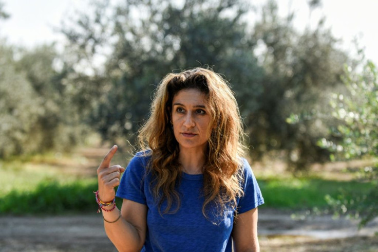 Elena Sampson sighs at the sight of hundreds of barren trees in her olive orchard, hit be heatwave after heatwave