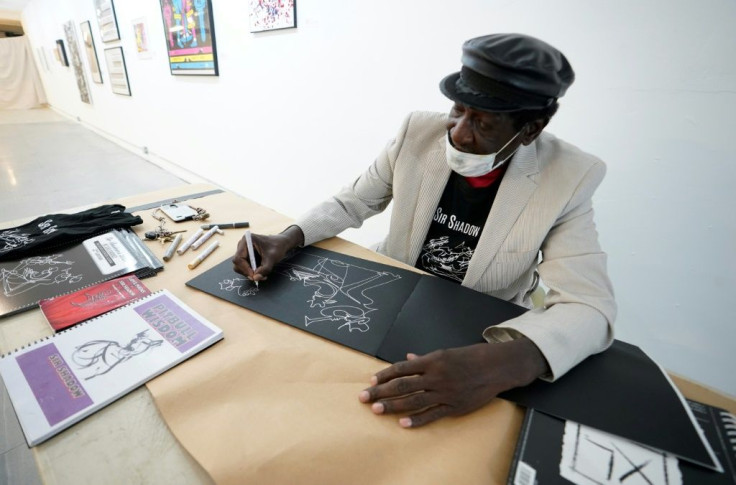 The artist known as Sir Shadow, who draws and exhibits his work in empty real estate spaces, draws one of his signature one-stroke drawings on November 25, 2020 in New York