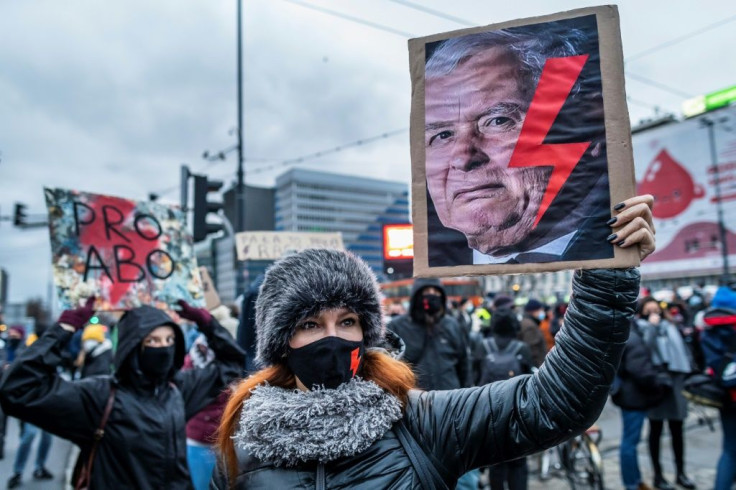 A court decision to ban terminations in cases of foetal anomaly has fomented protest -- here, a woman's anti ruling PiS party banner shows the red lightning bolt symbol of the women's strike movement