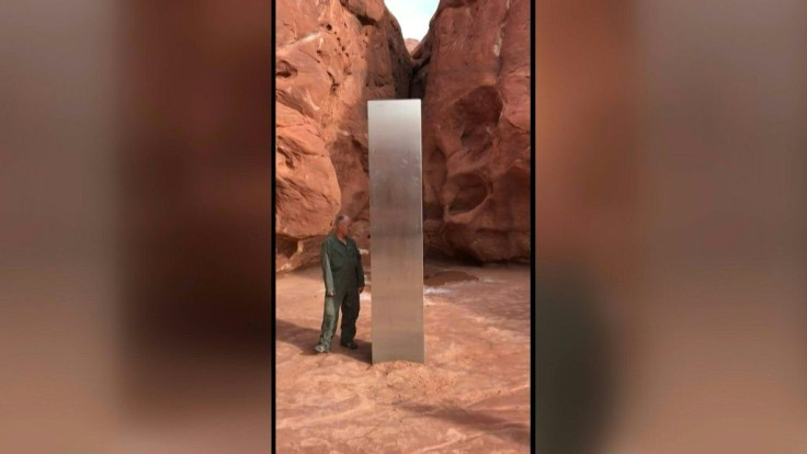 US crew members find a metal monolith installed in the ground in a remote area of Red Rock Country, in southeastern Utah.