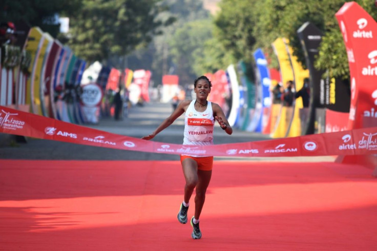 Ethiopian athlete Yalemzerf Yehualaw runs towards the finish line to win the women's 2020 Airtel Delhi half marathon in New Delhi