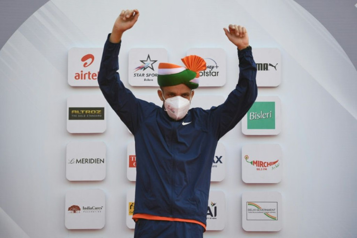 Ethiopian athlete Amedework Walelegn celebrates at the podium after winning the men's 2020 Airtel Delhi half marathon in New Delhi