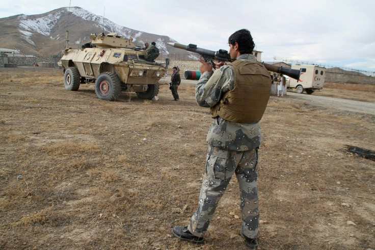 An Afghan soldier with a rocket-propelled grenade launcher near the site of the suicide car bomb attack in Ghazni