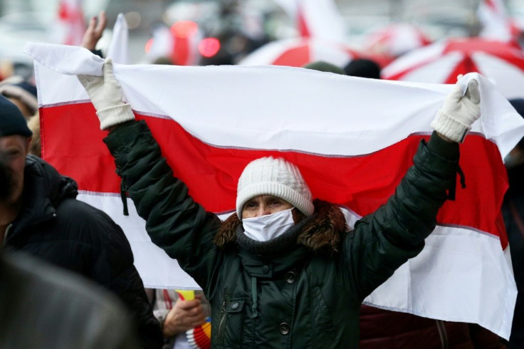 A woman carrying the white-red-white flag used by the anti-Lukashenko movement on November 23