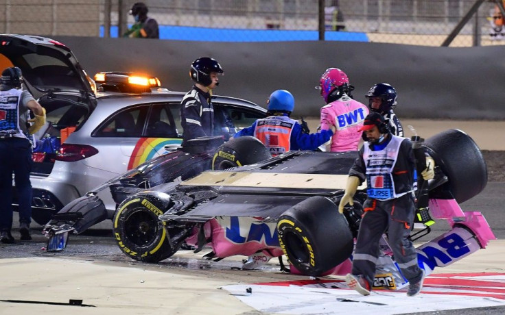 Racing Point's Canadian driver Lance Stroll (3rd-R) is helped into the medical car after crashing during the Bahrain Formula One Grand Prix