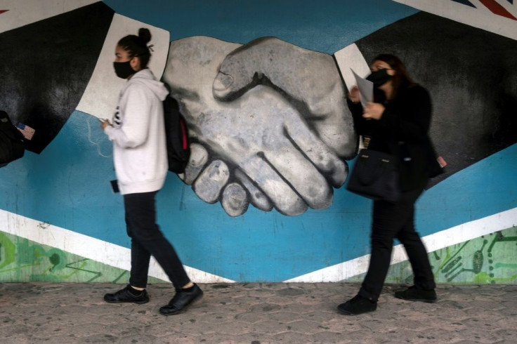 Commuters queue in Tijuana to cross the border from Mexico to the United States