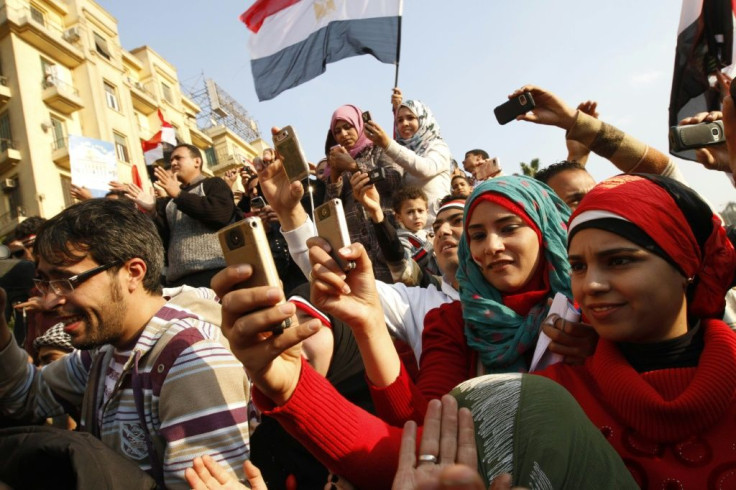 Egyptians use their mobile phones to record celebrations on February 12, 2011 in Cairo's Tahrir Square