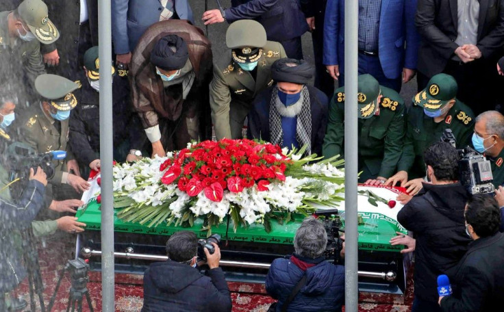 Iranian officials pray over the coffin of slain top nuclear scientist Mohsen Fakhrizadeh during his funeral ceremony in the capital Tehran, in a picture supplied by the conutry's defence ministry