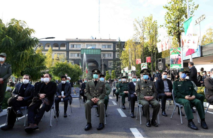 Sons (L) of slain Iranian top nuclear scientist Mohsen Fakhrizadeh and military officials at Monday's funeral within the defence ministry