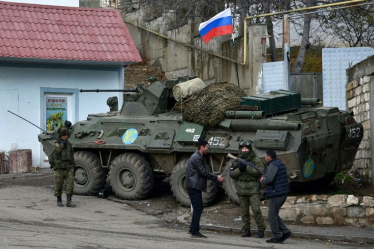 AFP journalists in Lachin town saw a column of Azerbaijani trucks flanked by military vehicles from Russia