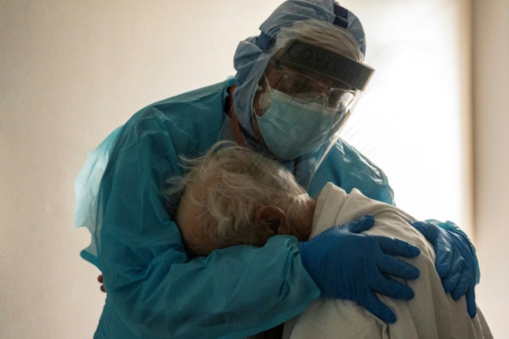 Dr. Joseph Varon comforts a patient in the Covid-19 intensive care unit during Thanksgiving at the United Memorial Medical Center in Houston, Texas