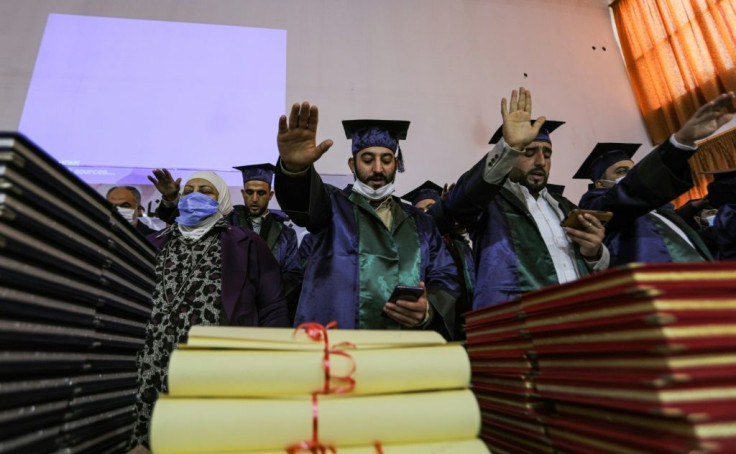 New Syrian doctors recite the Hippocratic Oath after graduating from an opposition-backed university in the country's rebel-held north