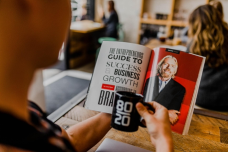 A Man Reading a book about Business Growth