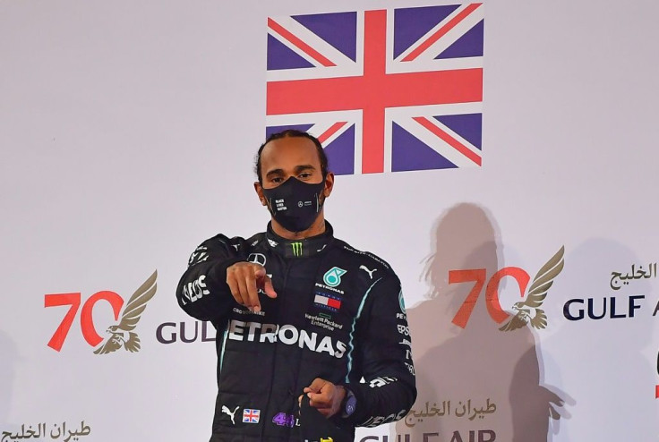 Formula One world champion Lewis Hamilton -- seen here celebrating his victory in Bahrain -- has tested positive for the virus