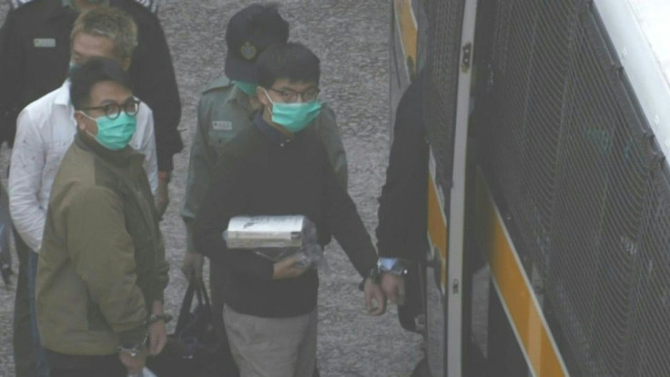 IMAGESHong Kong pro-democracy activists Joshua Wong and Ivan Lam on Wednesday exit prison to board a police van ahead of sentencing in court over a protest which took place outside the police headquarters in 2019