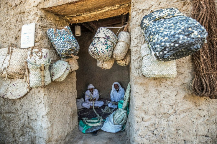 Craftsmen work on traditional palm wicker baskets at their shop in Egypt's western desert oasis of Siwa, home to the Siwi language