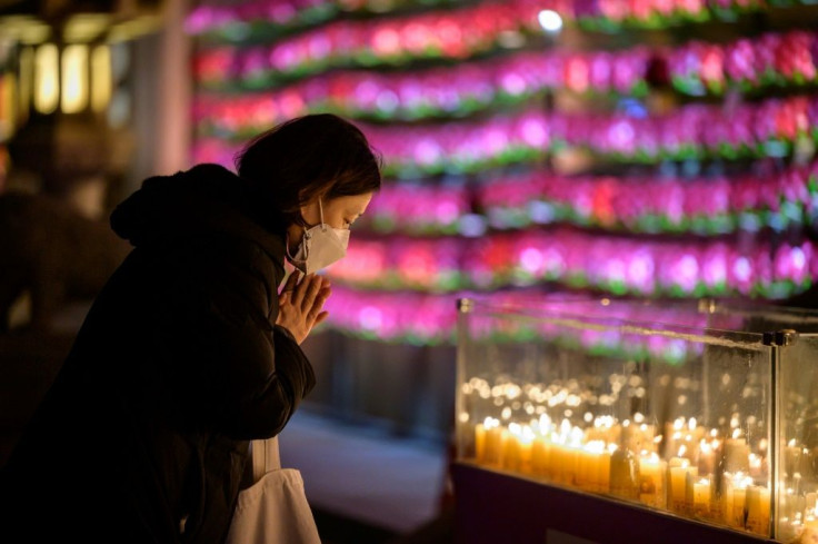 Worshippers offer prayers for loved ones on the eve of South Korea's annual college entrance exams, due to take place Thursday under the cloud of the coronavirus