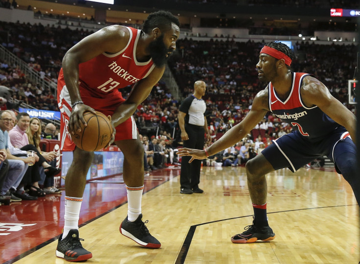 James Harden #13 of the Houston Rockets controls the ball defended by John Wall #2 of the Washington Wizards