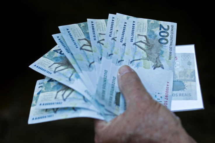 A man holds two hundred-reais notes after Brazil's Central Bank issued them in Brasilia, in September 2020