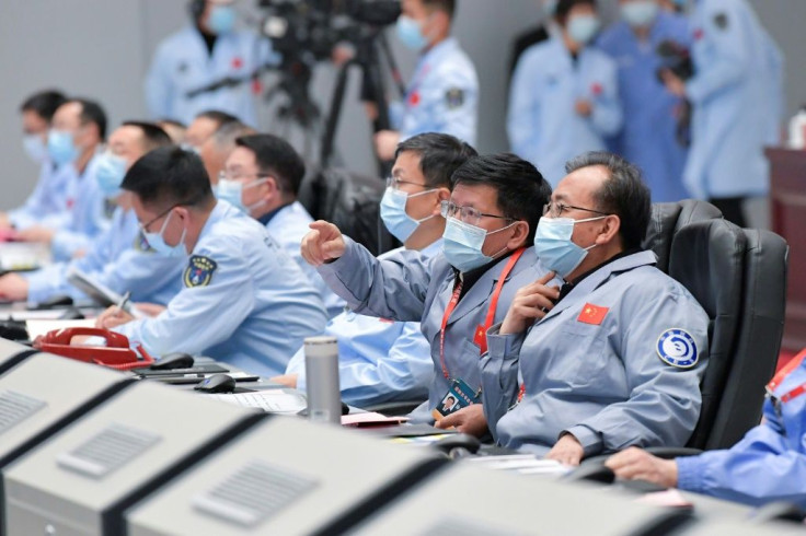 Technical personnel monitor the Chang'e-5 lunar probe landing on the moon from the Beijing Aerospace Control Center in Beijing