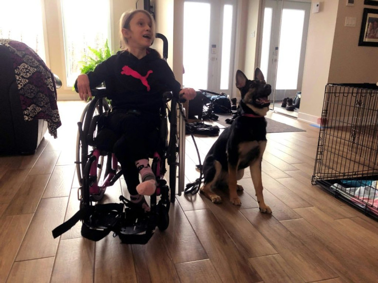 Oceane McKenzie, 11, who suffers from cerebral palsy, is seen with her new puppy Oakley at home in Quebec, Canada on December 1, 2020