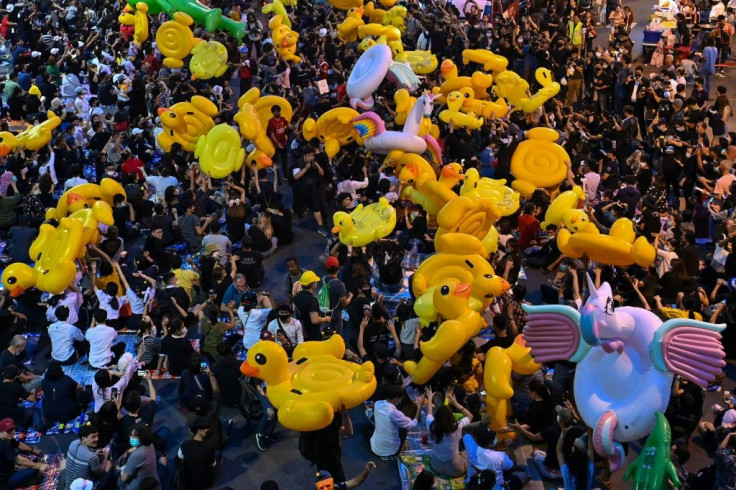 Pro-democracy protesters carry large inflatable ducks during an anti-government rally at Lat Phrao intersection in Bangkok