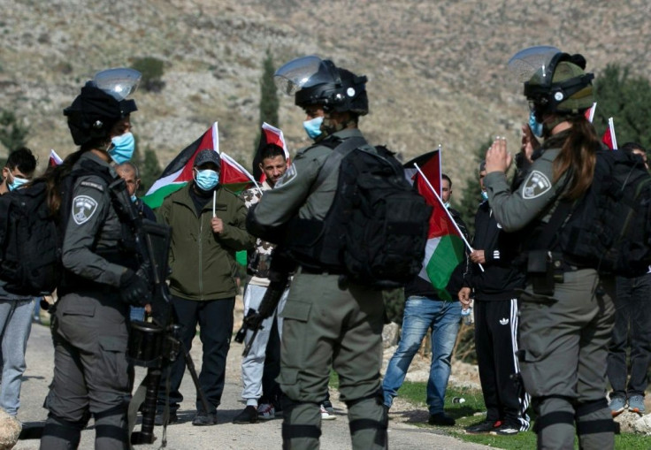 Palestinian demonstrators face Israeli forces during a protest against Israeli settlements in Kafr Malik in the occupied West Bank on December 4, 2020, the same day a Palestinian teenager was killed in clashes in the village of Mughayir