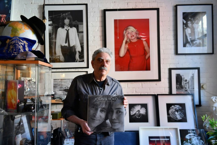 Photographer Allan Tannenbaum inside his Soho studio, with his book entitled "John and Yoko: A New York Love Story" of photos he took of the iconic couple